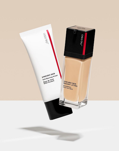 Product shot of Shiseido Synchro Skin primer and foundation on a light background, showcasing makeup for beauty and skincare.