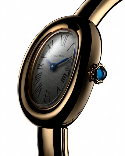 Elegant close-up of a gold-tone Cartier wristwatch with a grey face, Roman numerals, and blue hands, set against a clean white backdrop.