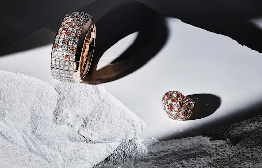 Close-up shot of a diamond bracelet and ring on a textured surface, capturing the luxury jewelry with detailed craftsmanship and design.
