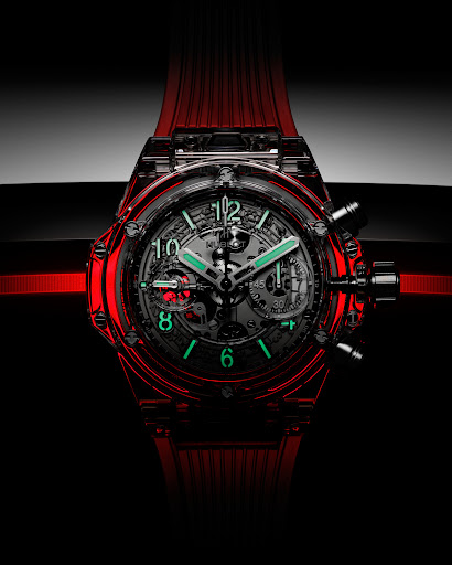 Close-up studio shot of a transparent red wristwatch with visible gears, set against a dark background highlighting its intricate design.