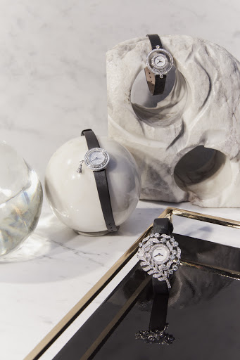Elegant timepiece product shot. Wristwatches with black leather straps displayed on geometric white marble, marble background, studio lighting.