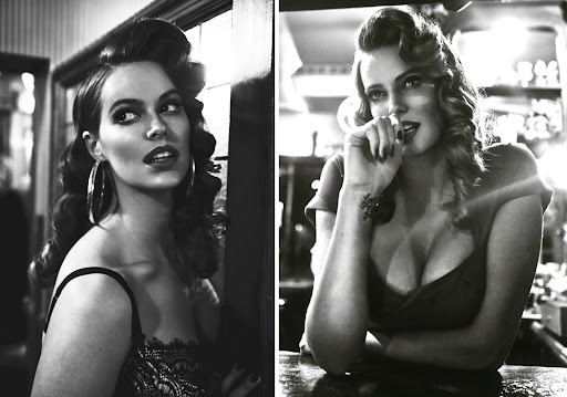 Black and white portrait of two adult women with retro hairstyle and makeup, posing indoors, in a vintage style reminiscent of old Hollywood.