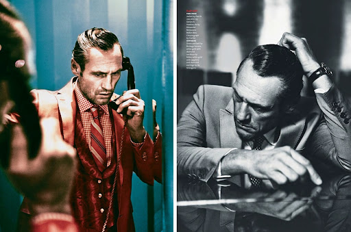 A man in a red suit on the phone reflects in a mirror beside a monochrome portrait of a man at a table resting his head in his hand.