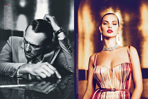 Double page fashion magazine spread featuring a man in a grey suit and a woman in a striped dress with diamond necklace