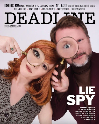 Magazine cover featuring Natasha Lyonne and Rian Johnson, each holding magnifying glasses to one eye against a white background.