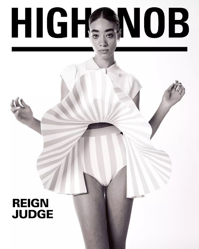 Fashion editorial featuring a model in a striped outfit against a white backdrop, with the text 'HIGHNOB' and 'REIGN JUDGE' visible.