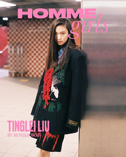 Fashion editorial cover: Asian woman poses in black blazer indoors with a checkered background, cover text, and bold pink logo.
