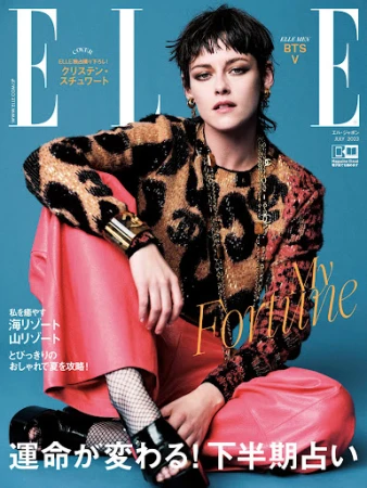Elle magazine cover featuring Kristen Stewart in a leopard-print top and red pants, seated against a blue background. Magazine text visible.