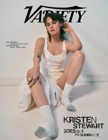 Kristen Stewart seated against a white background wearing a white tank top and white socks, with Variety magazine header.