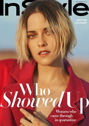 Magazine cover featuring Kristen Stewart in a red jacket against a soft background with headline text and magazine logo.