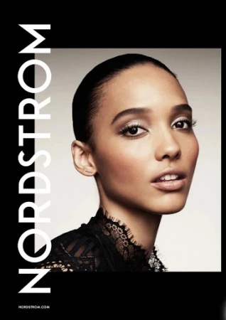 Close-up beauty portrait of an adult female model in a black lace top against a gradient background, next to Nordstrom logo and website.