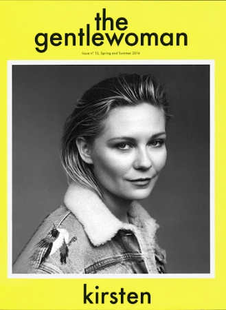 Black and white portrait of Kirsten Dunst wearing an embroidered denim jacket with a sherpa collar on a magazine cover with yellow border