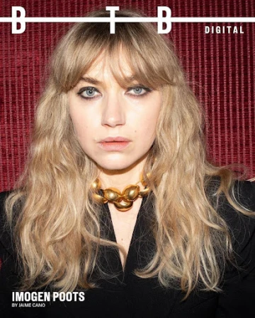Close-up portrait of actress Imogen Poots with blonde hair, bangs, black eyeliner, and a gold statement necklace.