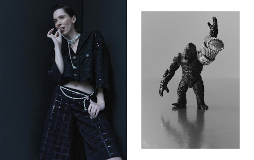 Fashion editorial shot of a woman in a black beaded suit and a toy gorilla adorned with rings against a black and gray background.