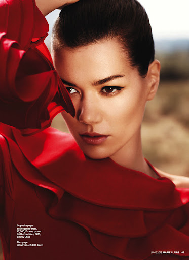 Close up portrait of a woman in a red silk dress with dramatic eye makeup by makeup artist Mary Wiles.