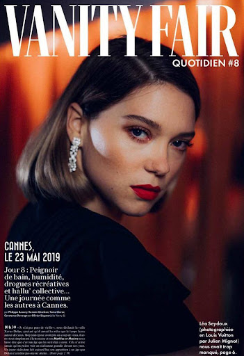 Close-up portrait of a blonde woman with red lipstick and sparkling earrings, featured on the cover of Vanity Fair Quotidien #8.