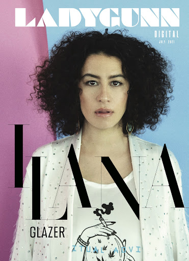 Liana Glazer on Ladygunn Digital Magazine cover, July 2021. Portrait of woman with dark curly hair in front of pink and blue background.