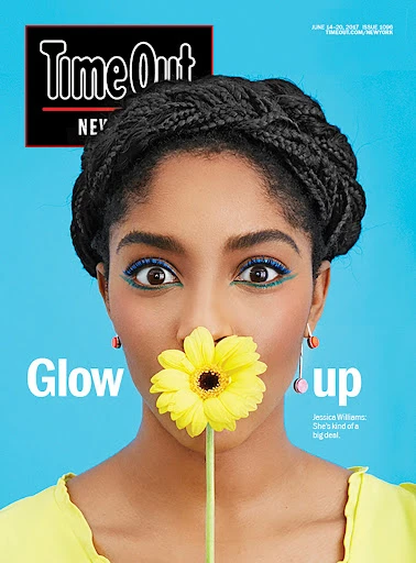 Time Out New York magazine cover featuring a Black woman with braided hair holding a yellow daisy in front of her mouth.