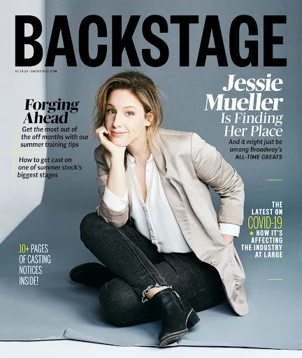 Backstage magazine cover featuring Jessie Mueller, who is casually seated with a hand to her face, wearing a blazer and dark jeans.