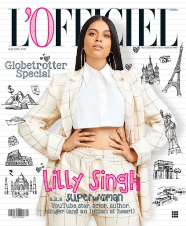Magazine cover featuring Lilly Singh with makeup by Rebecca Restrepo, wearing a cream plaid suit and white collared shirt.