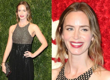 Emily Blunt in a black sequin gown with a mesh halter neckline posing against a green foliage wall