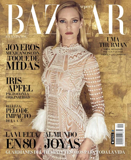 Magazine cover featuring Uma Thurman in a sheer patterned dress against a gold background with magazine title and cover text.