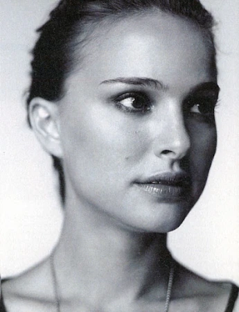 Close up portrait of a woman looking to the side against a plain white background in black and white