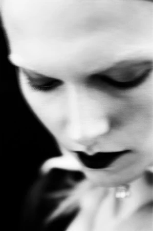Close-up portrait of a woman with dark lipstick in Paris by makeup artist Sohphea
