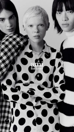 A black-and-white studio shot features three people posing in patterned shirts, the main focus on the center individual. Modern fashion.