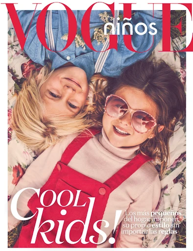 A fashion magazine cover shows a blonde-haired child and a dark-haired child wearing sunglasses, laying on a floral pattern with vogue logo.