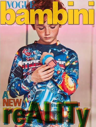 Vogue Bambini magazine cover featuring a child model with red hair wearing a space-themed shirt and accessorized with a smart watch.
