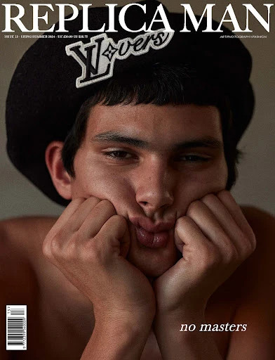 Replica Man magazine cover featuring a portrait of an adult male model with dark hair and a black hat with a logo detail.