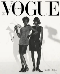Monochrome fashion magazine cover featuring two Black models posing with a vintage megaphone against a plain white background.
