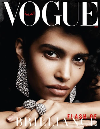 Vogue Arabia cover featuring a close-up portrait of a striking woman with ornate silver jewelry against a dark background.  