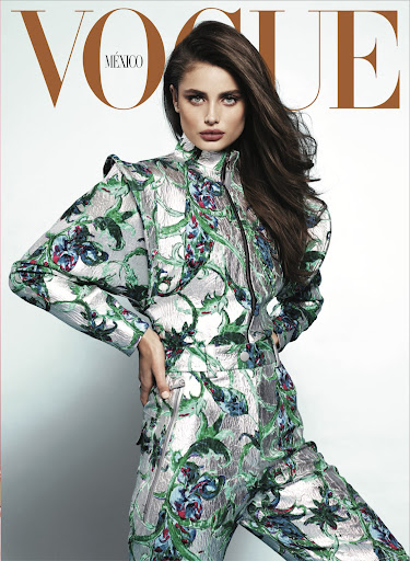 Vogue Mexico cover featuring a brunette woman in a floral patterned suit, striking a pose against a plain background. Fashion editorial shot.
