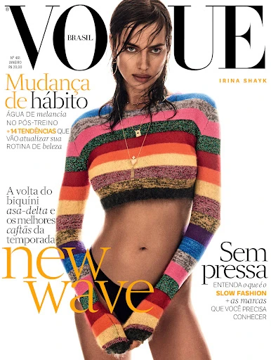 Vogue Brasil cover featuring Irina Shayk in a colorful striped crop top and black bikini bottom against a white background.