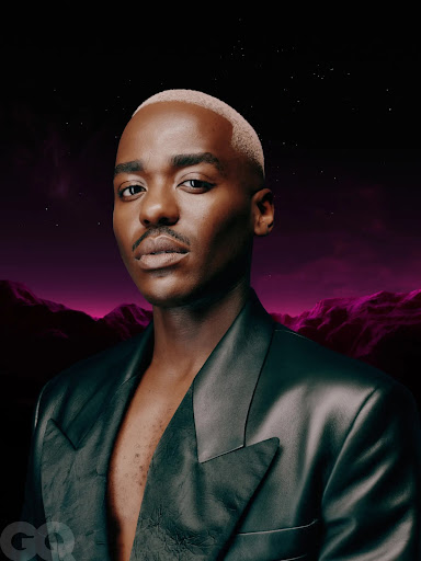 Portrait of Black male adult in black leather jacket, styled with short bleached hair, against a digital landscape background. GQ logo visible.