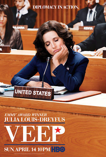 Poster for the TV show Veep featuring Julia Louis-Dreyfus as Selina Meyer, seated at a table with a United States placard.