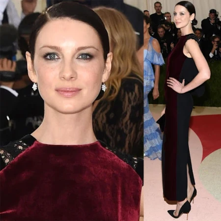 Caitriona Balfe poses in a black gown with burgundy velvet accents on a red carpet, at a celebrity event with onlookers.