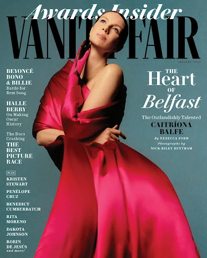 Caitríona Balfe graces the cover of Vanity Fair magazine, January 2022 issue, in a draped red gown looking upwards. Magazine cover.