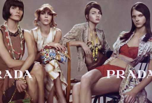 Fashion editorial featuring four diverse female models in vintage-inspired clothing and accessories, posing against a neutral studio backdrop.