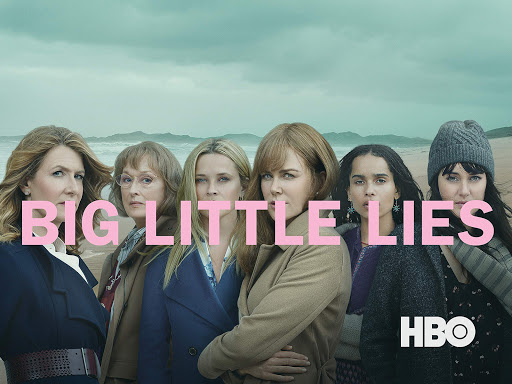 Group shot of six actresses in fashionable coats on a beach, promoting the HBO series Big Little Lies. Dramatic lighting and coastal backdrop.