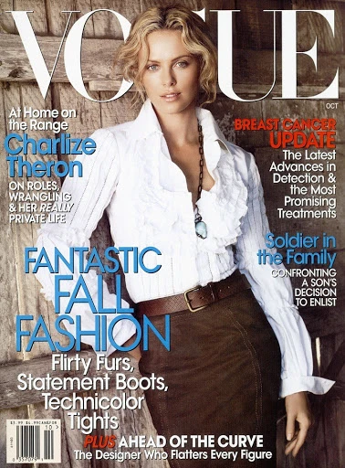 Vogue magazine cover featuring a woman in a white ruffled shirt and brown skirt, set against a rustic wood background. Fashion editorial.