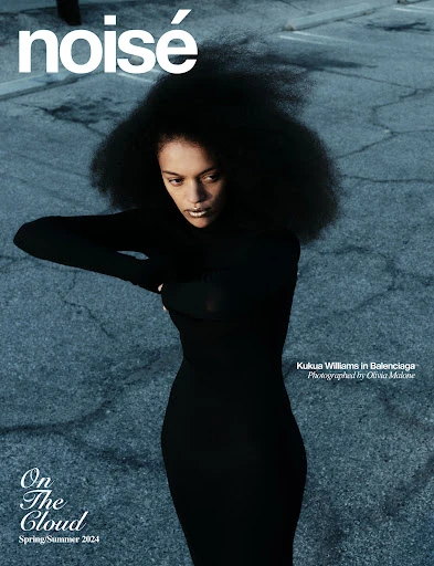 Fashion magazine cover featuring a Black woman with afro, wearing a black dress, posing against an urban background with visible text.