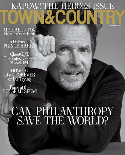 Magazine cover featuring Michael J. Fox in black and white, with a headline about philanthropy and health issues, against a neutral backdrop.