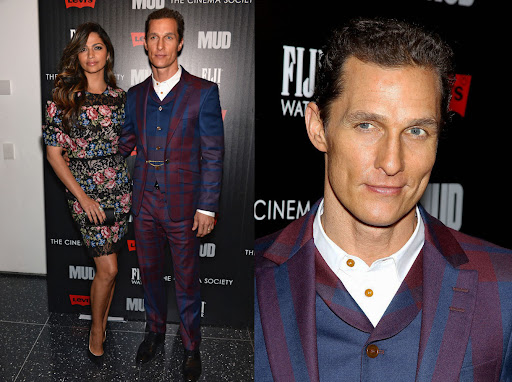Matthew McConaughey and Camila Alves attend a premiere event, posing in a photo studio with dark background and soft studio lighting.