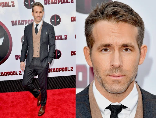 Ryan Reynolds poses on a red carpet in a grey suit and brown vest at a Deadpool 2 premiere, portrait and full-length views.