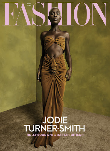 Fashion magazine cover featuring Jodie Turner-Smith in a gold dress, set against an olive green backdrop with stylish typography.