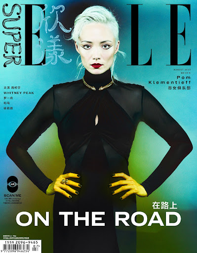 Elle magazine cover featuring Pom Klementieff, fashion model, in black dress with gold necklace, against blurred teal background.