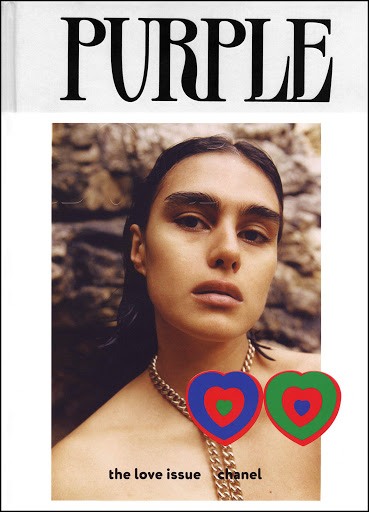 Magazine cover featuring a portrait of a young woman with a stone background and heart graphics, fashion editorial style.